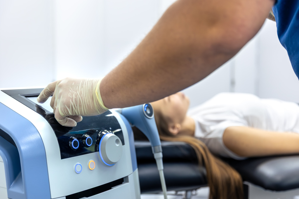 physiotherapist-adjusts-rehab-machine-with-female-patient-resting-therapy-setup-moment (1).jpg